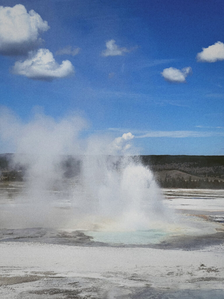 Fountain Paint Pots at Yellowstone National Park - a boiling, bubbling, and steaming hot spring that features vibrant colors due to the presence of bacteria and mineral deposits."